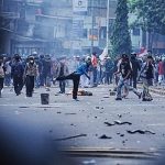 Riot police and students clash during protest against MPs’ allowances in Jakarta