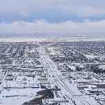 Drone footage shows snow-covered US cities, snow plows at work