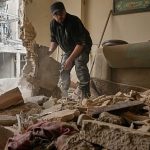 Residents clear rubble after strike damages buildings in southern Tehran