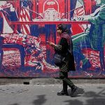 Iranians at home divided between hope for regime change and war fears