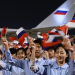 Chinese youths greet Putin on arrival in Beijing