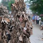 Catholics walk barefoot in mud ritual