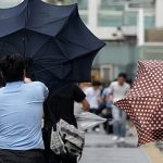 Flooded streets and rescues as Typhoon Dujuan hits Japan